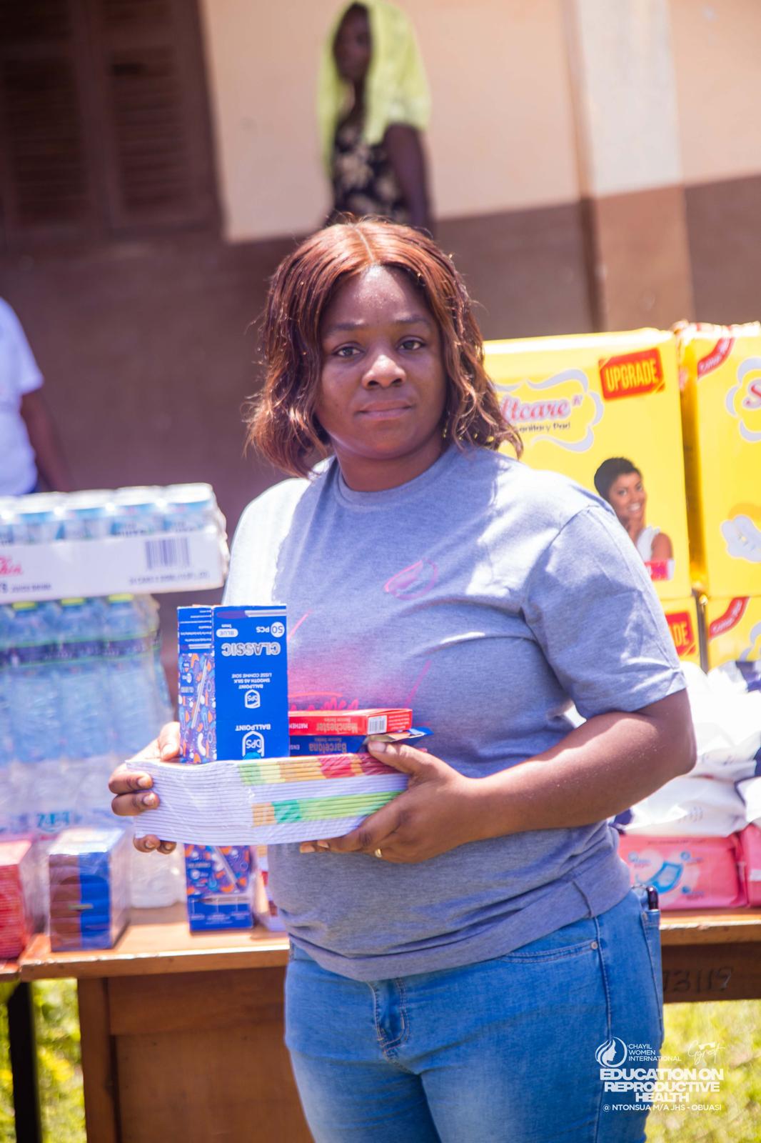 A CHAYIL volunteer holding stationery and hygiene items prepared for pupils